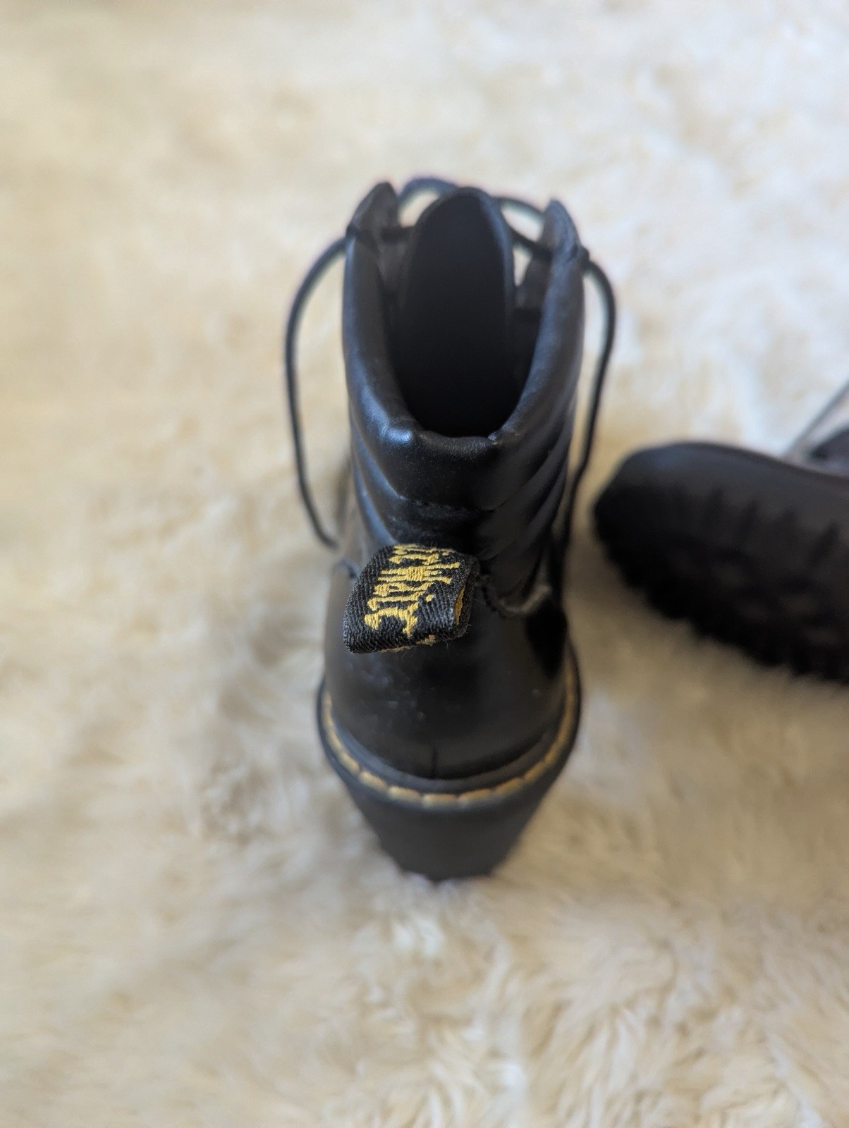 Black leather Dr. Martens Persephone heeled boots featuring a padded collar US 7
