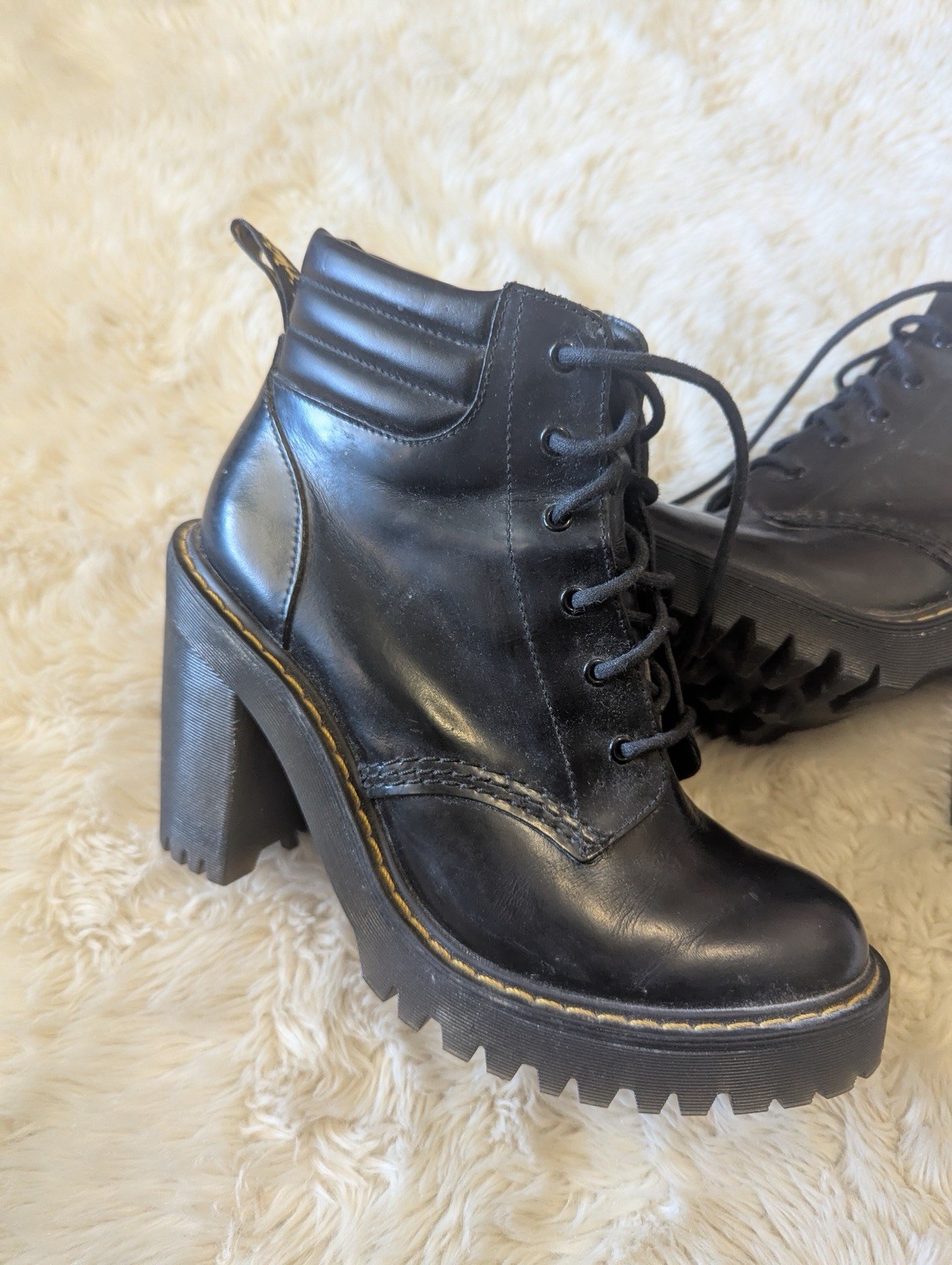 Black leather Dr. Martens Persephone heeled boots featuring a padded collar US 7