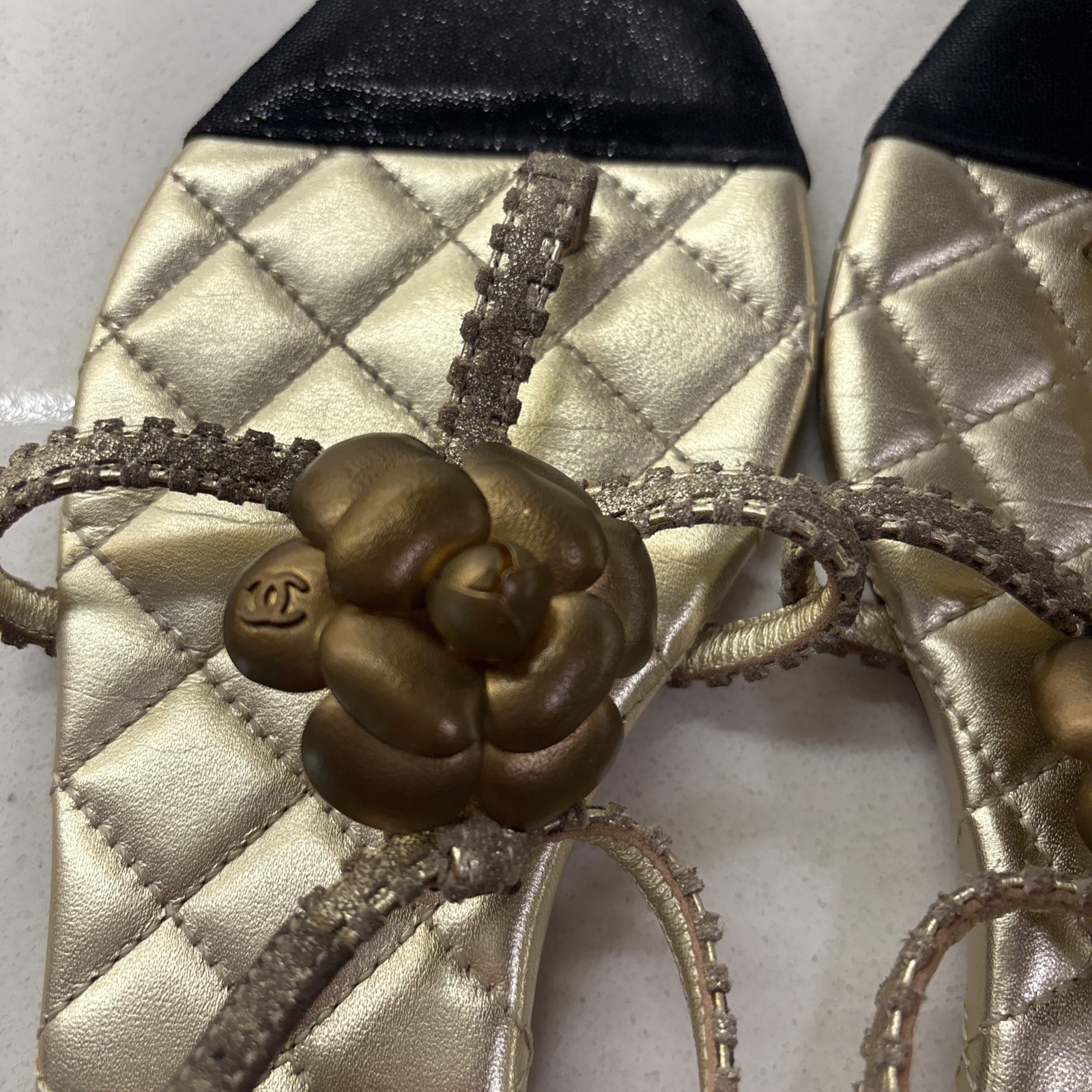 Chanel Gold Quilted CC Camellia Sandals, featuring a metallic bronze flower—EUC