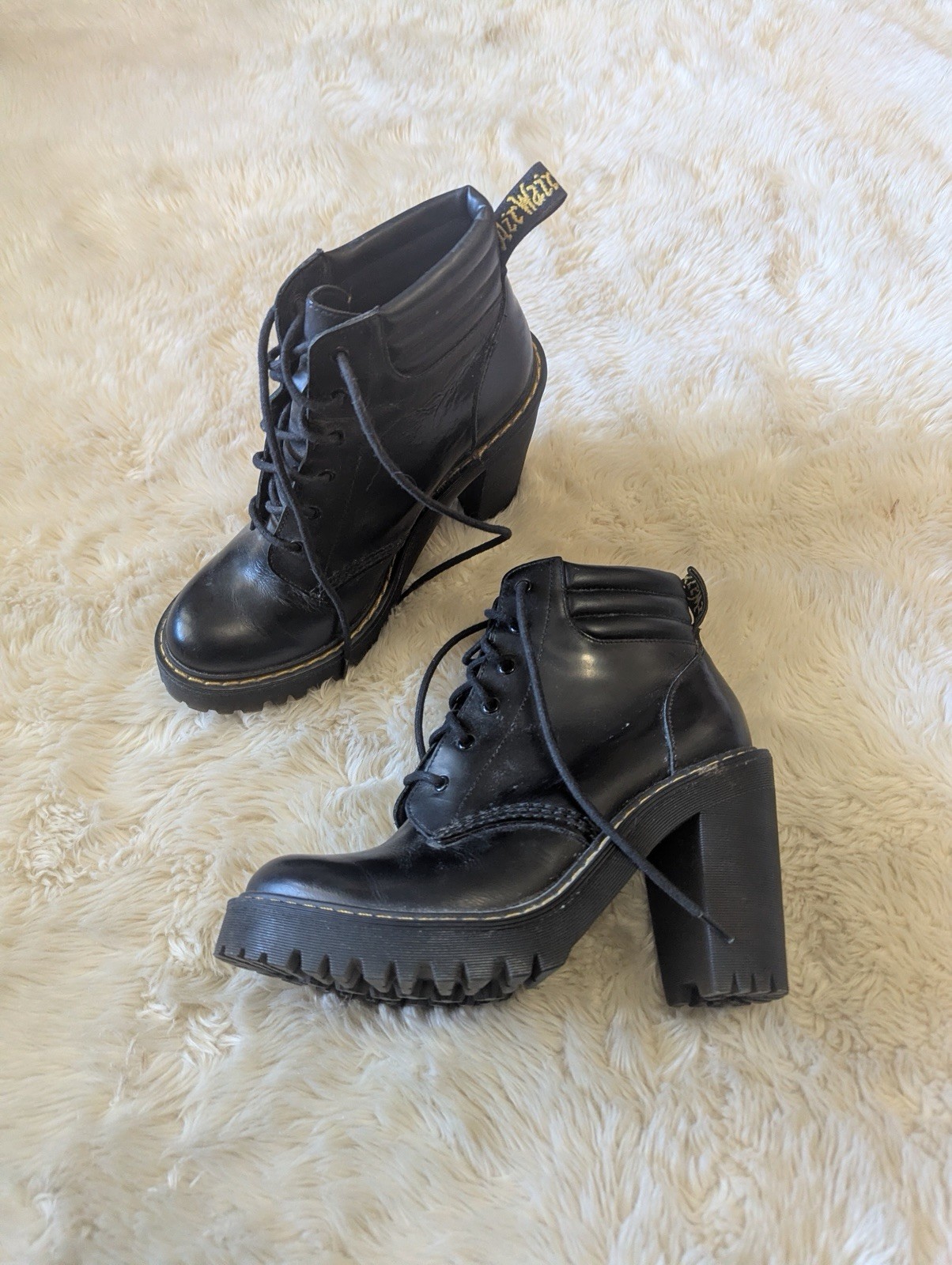 Black leather Dr. Martens Persephone heeled boots featuring a padded collar US 7