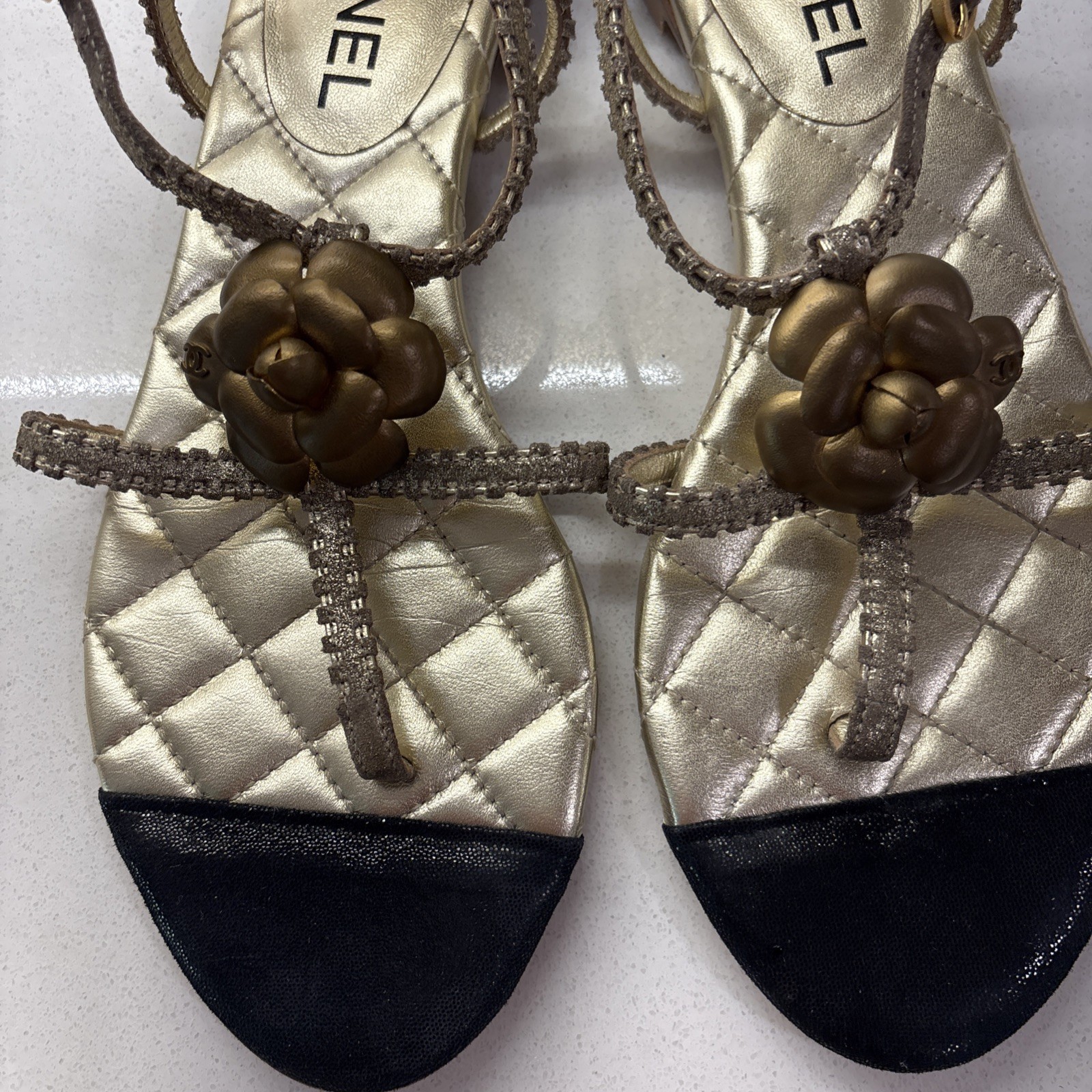 Chanel Gold Quilted CC Camellia Sandals, featuring a metallic bronze flower—EUC