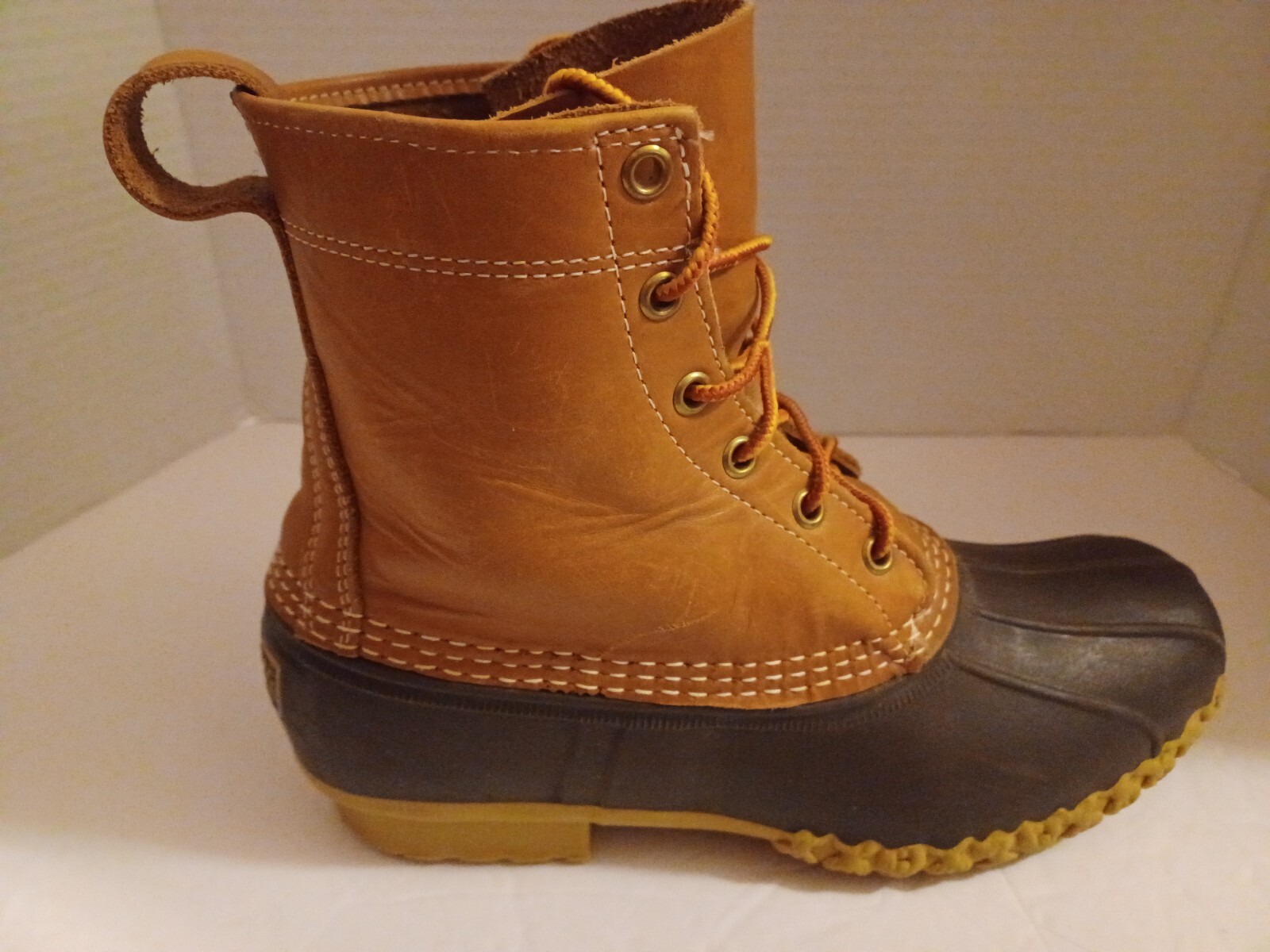L.L. Bean Boots Duck Boots Feature A Lace Up Closure With Pull Tab On Back.
