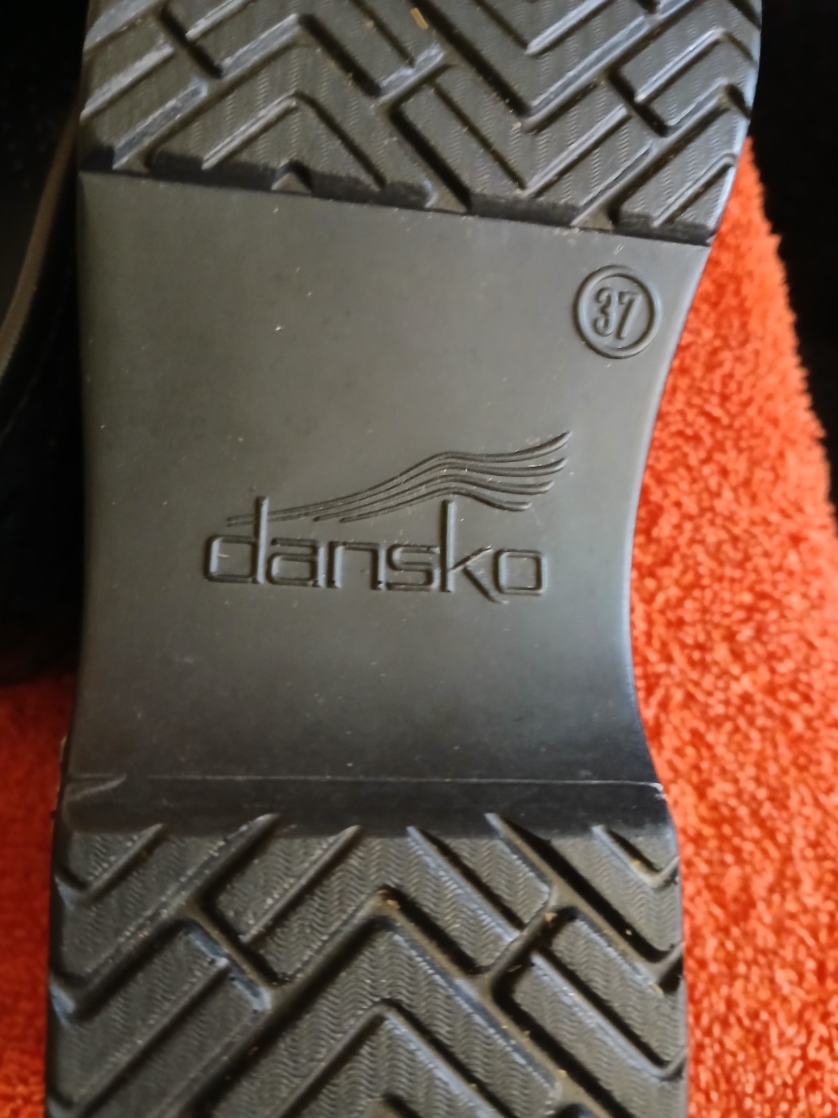 Dansko Professional clogs featuring a distinct floral patent leather finish….