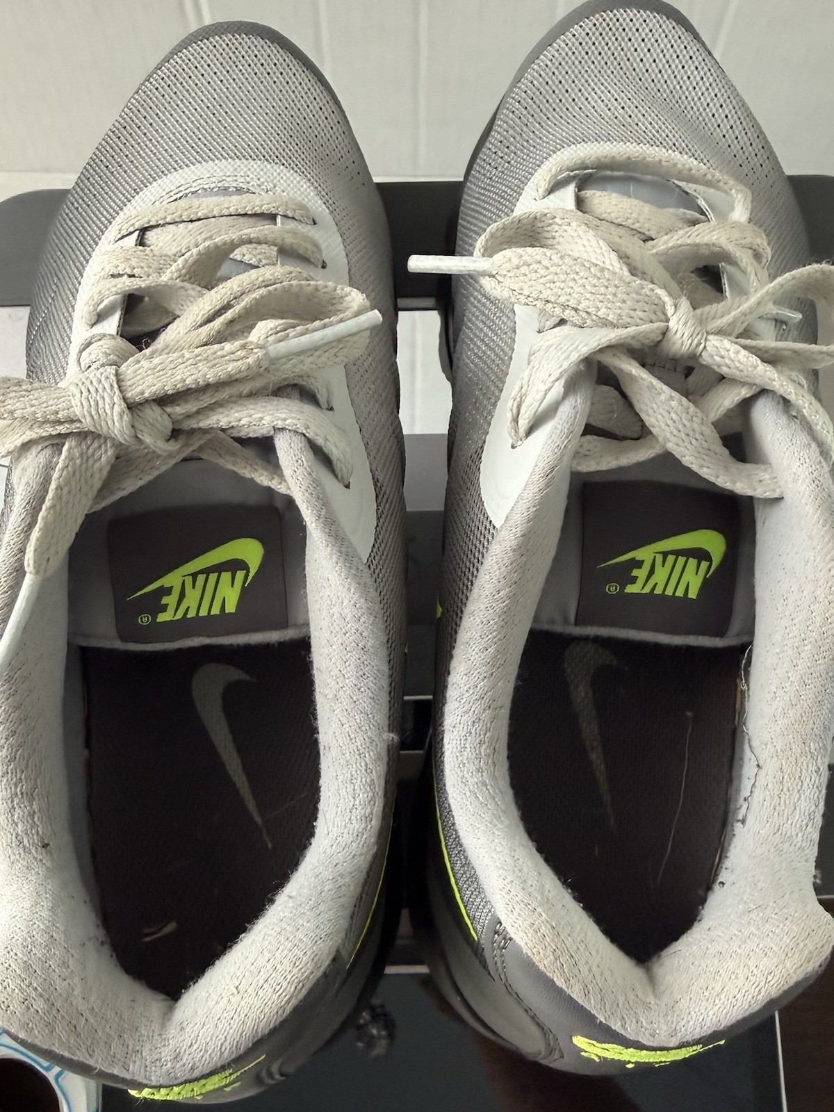 Nike Air Max Invigor sneakers, featuring a neon yellow Swoosh
