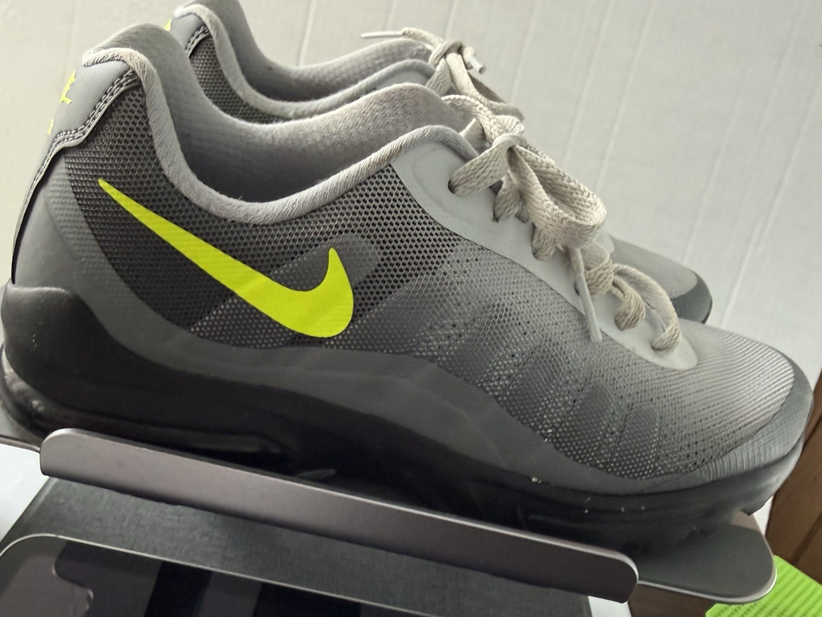 Nike Air Max Invigor sneakers, featuring a neon yellow Swoosh