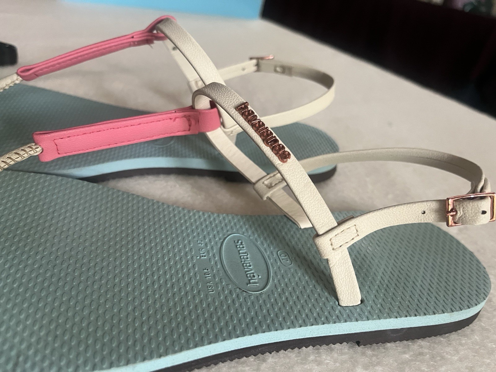 Havaianas You Rio sandals featuring a blue water sole and pink strap details.