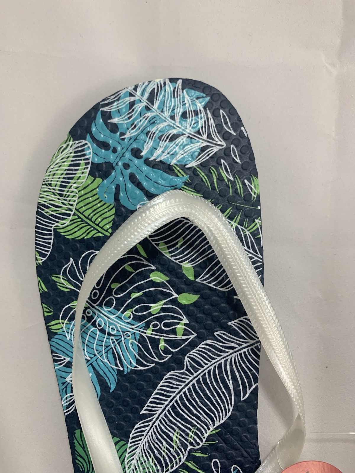 Juncture Women’s Flip Flops; Size Medium (7/8 ) Background color is dark blue.