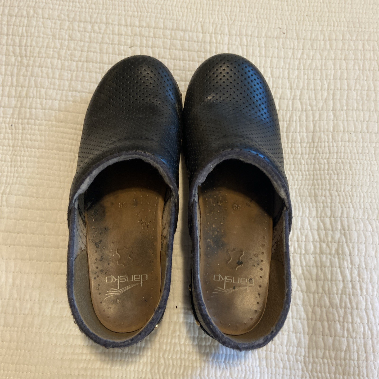 Dansko Pro Clogs In Black Leather With A Perforated Design And Gold-tone Studs