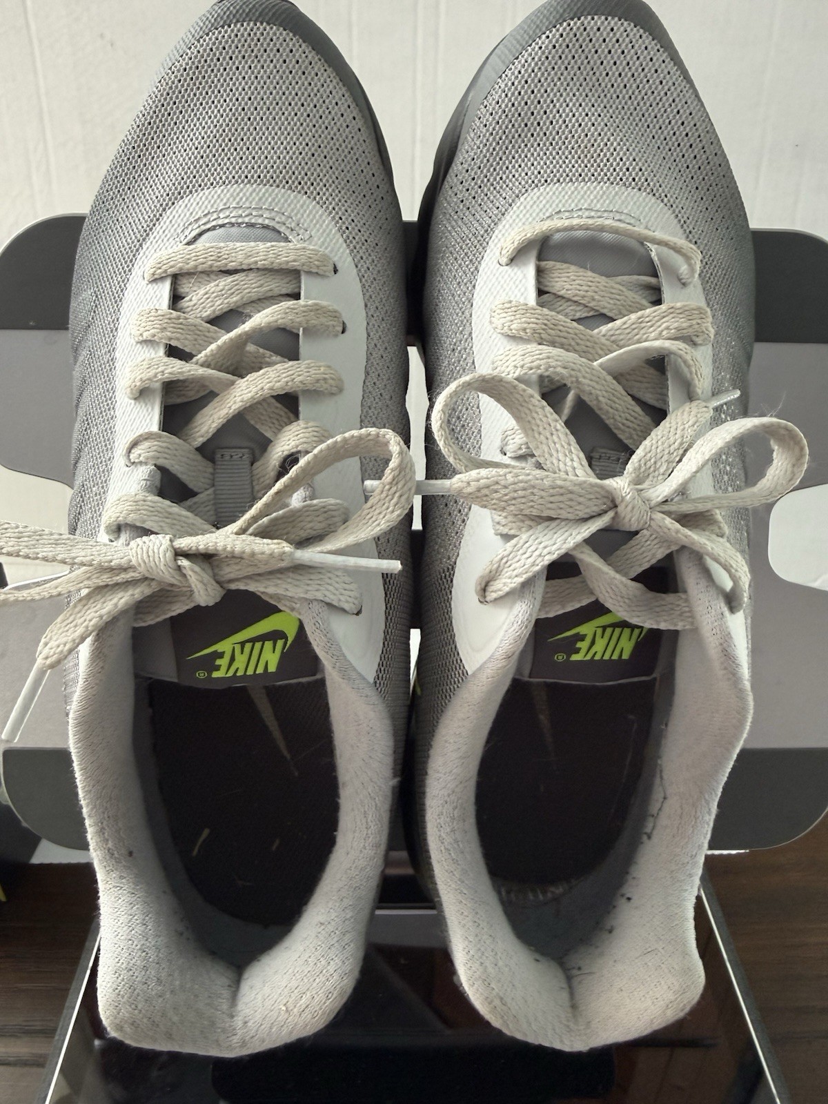 Nike Air Max Invigor sneakers, featuring a neon yellow Swoosh