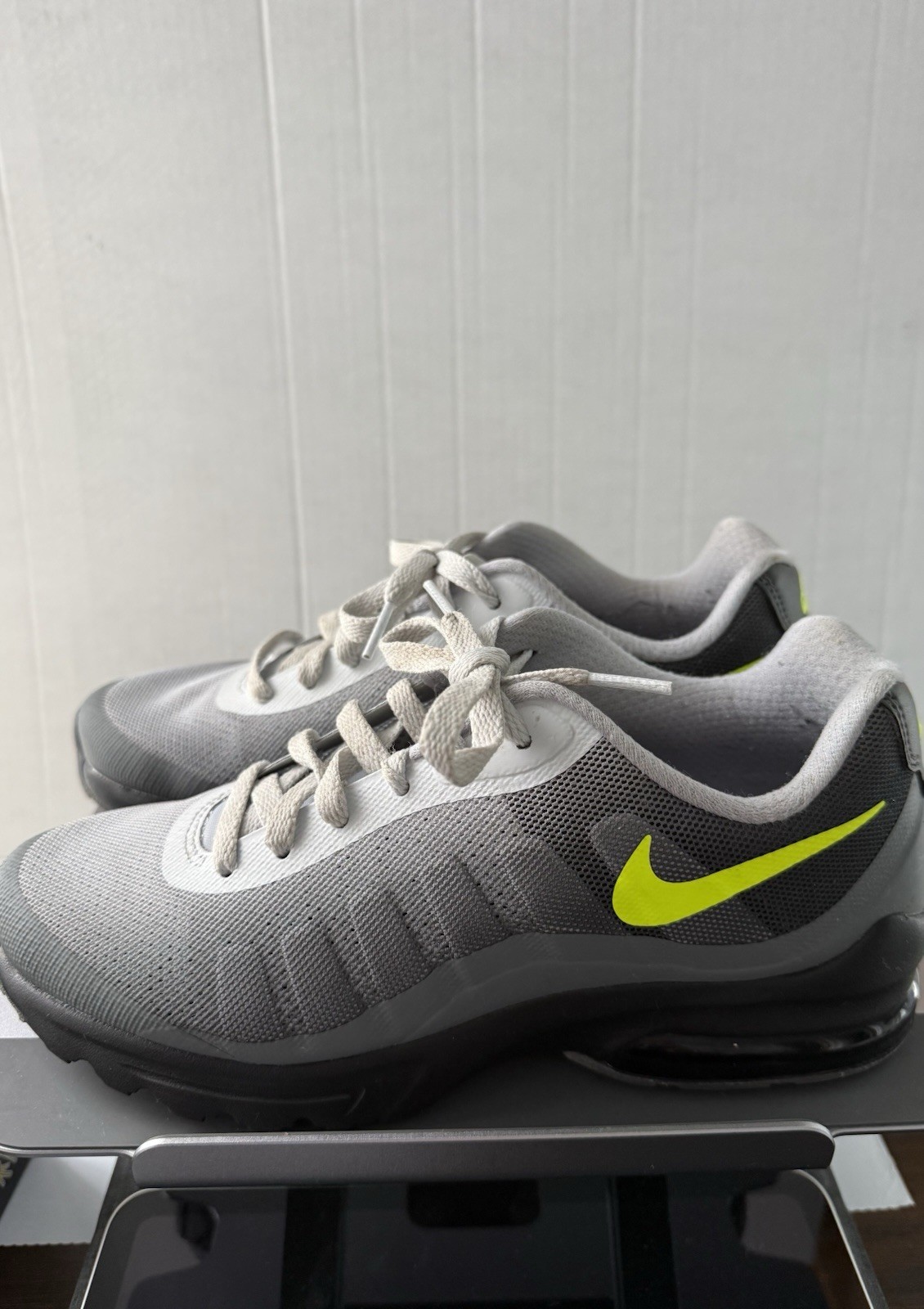 Nike Air Max Invigor sneakers, featuring a neon yellow Swoosh